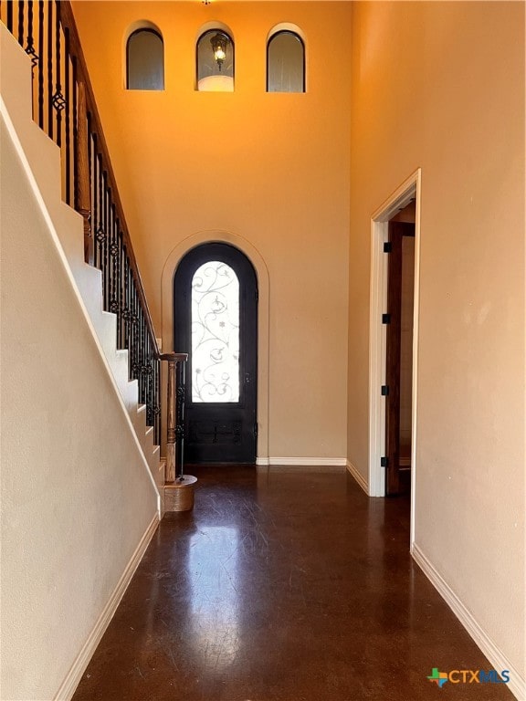 foyer entrance with a towering ceiling