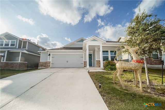 view of front of home with a front yard and a garage