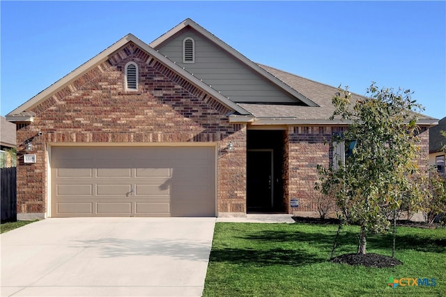 view of front of home with a garage and a front lawn