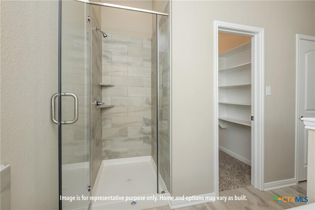 bathroom with wood-type flooring and walk in shower