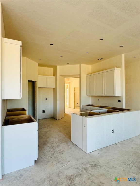 kitchen with a center island and white cabinetry