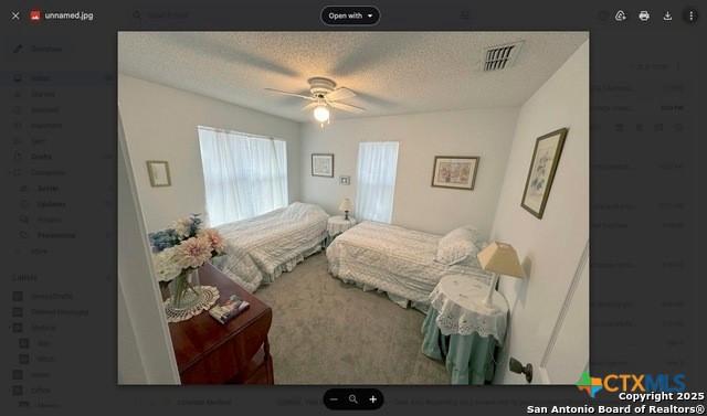 1254 Village Shore Dr, Canyon Lake, TX 78133 - bedroom with a textured ceiling and ceiling fan