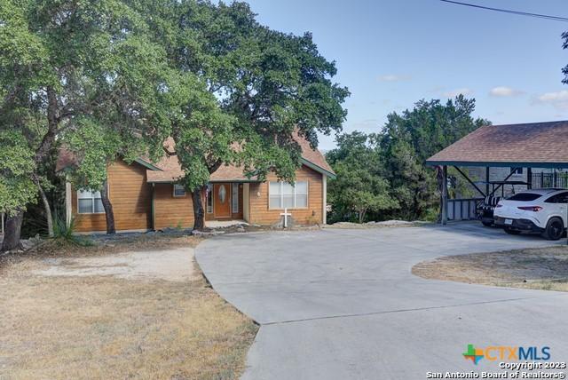 1254 Village Shore Dr, Canyon Lake, TX 78133 - view of front of home with concrete driveway