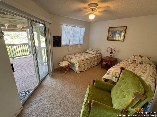 1254 Village Shore Dr, Canyon Lake, TX 78133 - bedroom with access to outside, carpet floors, a textured ceiling, and a ceiling fan