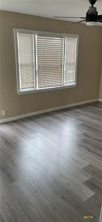 704 E Ave N, Temple, TX 76504 - unfurnished room with ceiling fan, wood finished floors, baseboards, and plenty of natural light