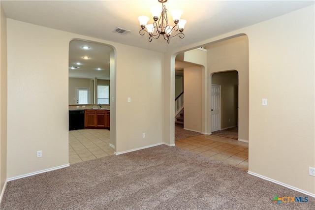 unfurnished room featuring arched walkways, a notable chandelier, light carpet, visible vents, and stairs