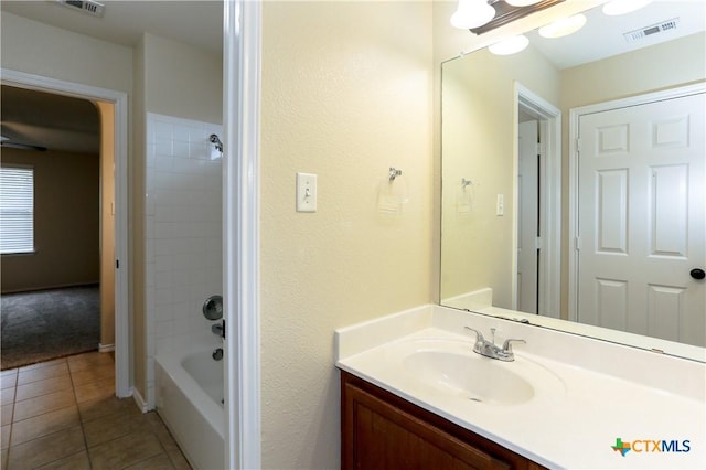 bathroom featuring tile patterned flooring, visible vents, vanity, and shower / tub combination