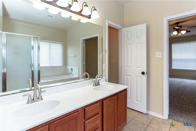 bathroom featuring a stall shower, visible vents, a sink, and tile patterned floors