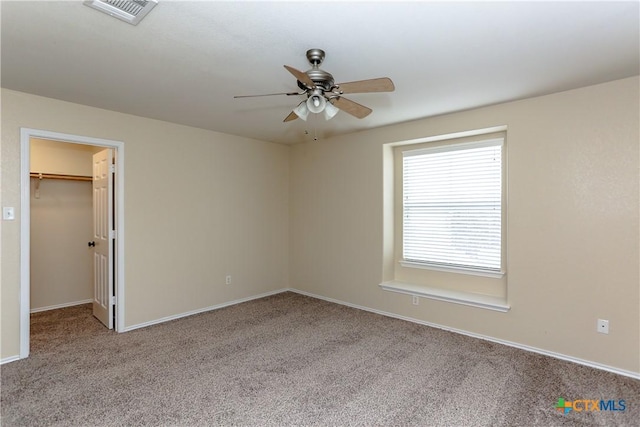 interior space featuring a ceiling fan, baseboards, visible vents, and carpet flooring