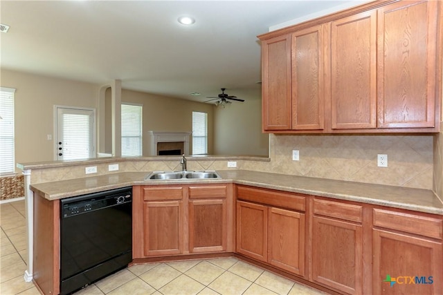 kitchen featuring a wealth of natural light, dishwasher, a peninsula, and a sink