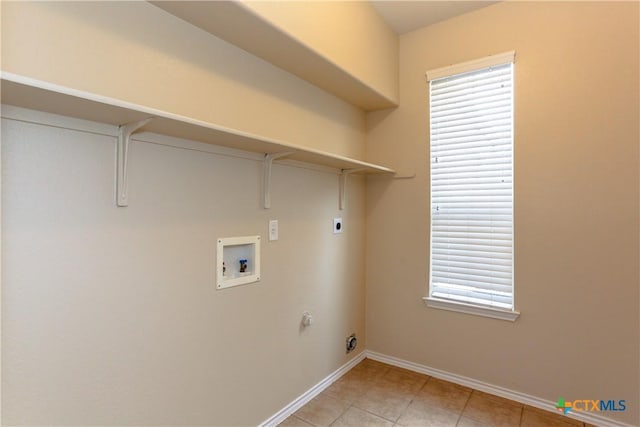 laundry area featuring washer hookup, light tile patterned floors, hookup for an electric dryer, laundry area, and baseboards