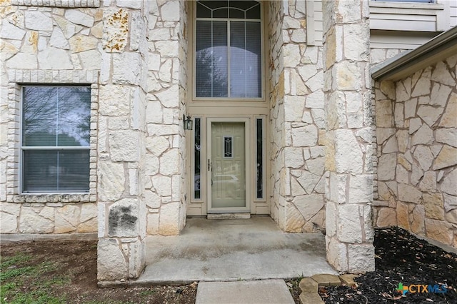 entrance to property with stone siding