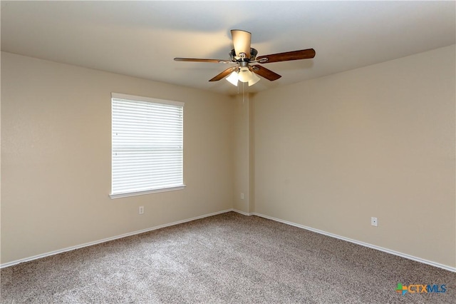 spare room featuring carpet and ceiling fan