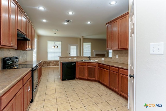 kitchen featuring visible vents, a sink, under cabinet range hood, and black appliances