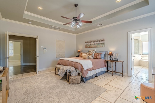 bedroom featuring ceiling fan, a raised ceiling, ornamental molding, and ensuite bathroom