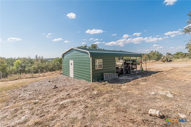 view of outdoor structure with a rural view