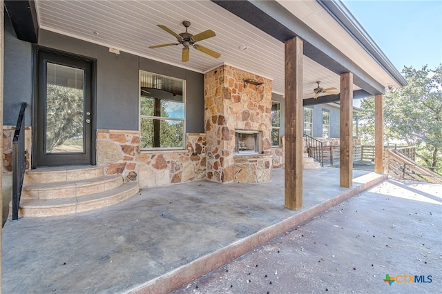 view of patio / terrace with ceiling fan and an outdoor stone fireplace