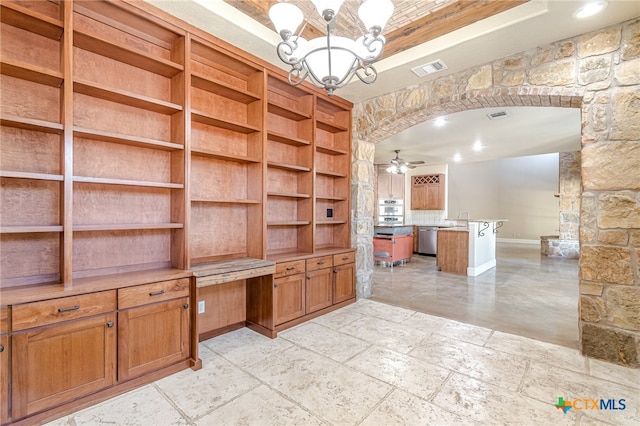 unfurnished office featuring sink and ceiling fan with notable chandelier