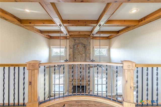 interior space with a wealth of natural light, hardwood / wood-style floors, and coffered ceiling