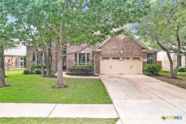407 Misty Morn Ln, Cedar Park, TX 78613 - view of property hidden behind natural elements with an attached garage, driveway, a front lawn, and brick siding