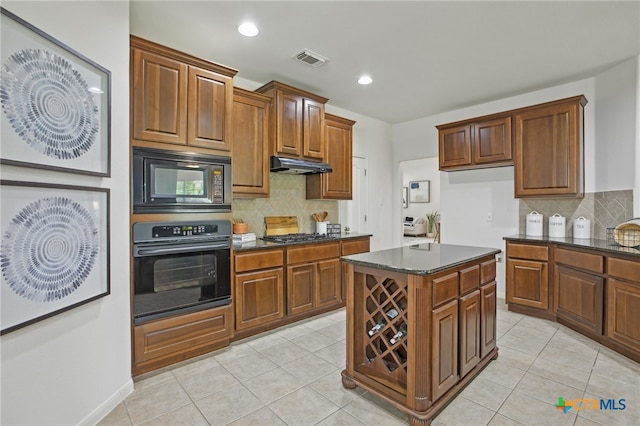 407 Misty Morn Ln, Cedar Park, TX 78613 - kitchen featuring light tile patterned flooring, visible vents, decorative backsplash, under cabinet range hood, and black appliances