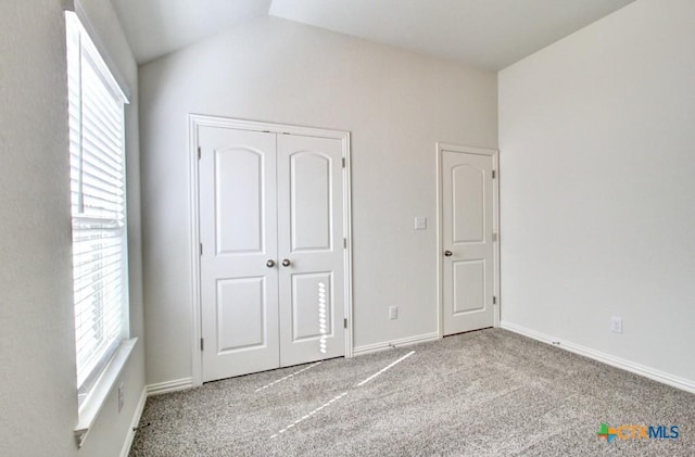 771 Navarro St, New Braunfels, TX 78132 - unfurnished bedroom featuring multiple windows, carpet flooring, vaulted ceiling, and a closet