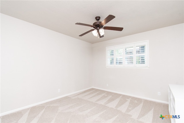 carpeted empty room with a textured ceiling and ceiling fan