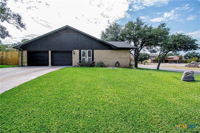 view of front of home with a front lawn and a garage