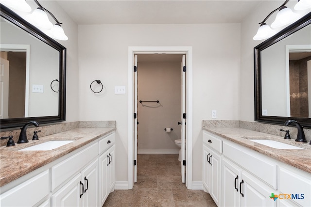 bathroom featuring vanity, tile patterned floors, and toilet