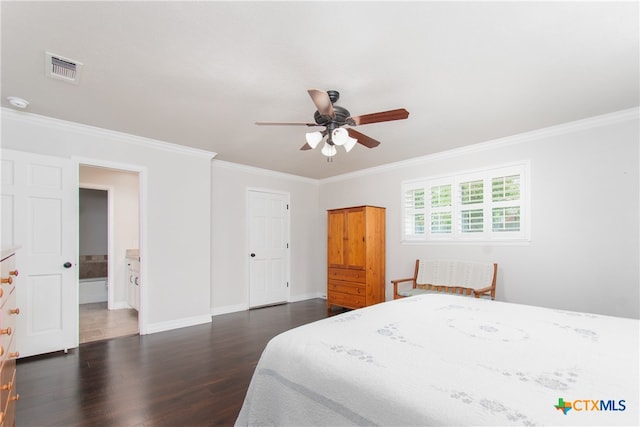 bedroom featuring ceiling fan, dark hardwood / wood-style floors, ensuite bath, and ornamental molding