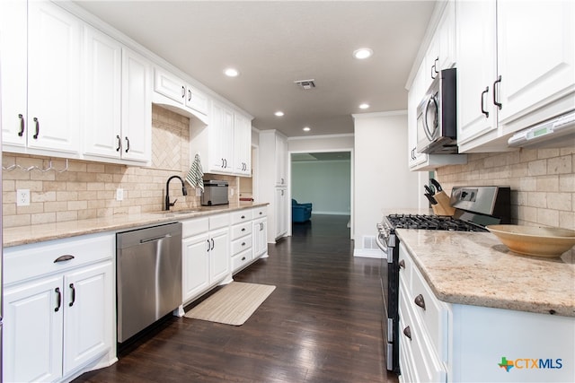 kitchen featuring white cabinets, stainless steel appliances, dark hardwood / wood-style floors, and light stone counters