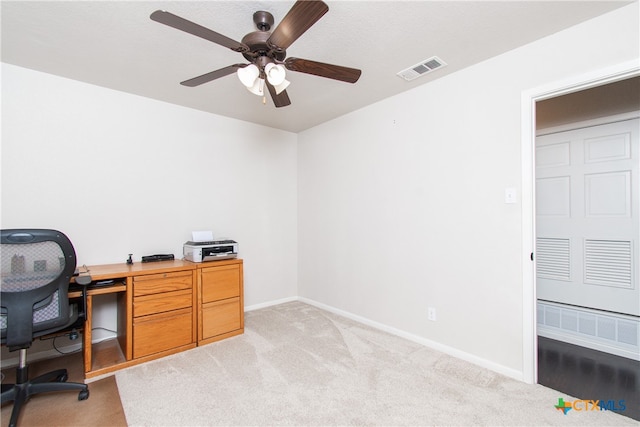 carpeted office space with ceiling fan