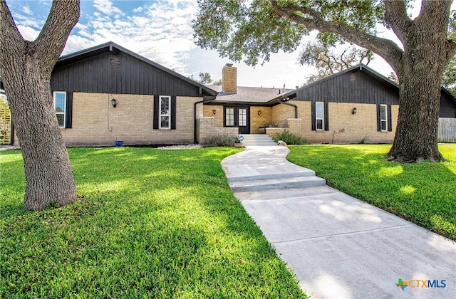 4101 Hickory Rd, Temple, TX 76502 - ranch-style house featuring brick siding, a chimney, and a front yard