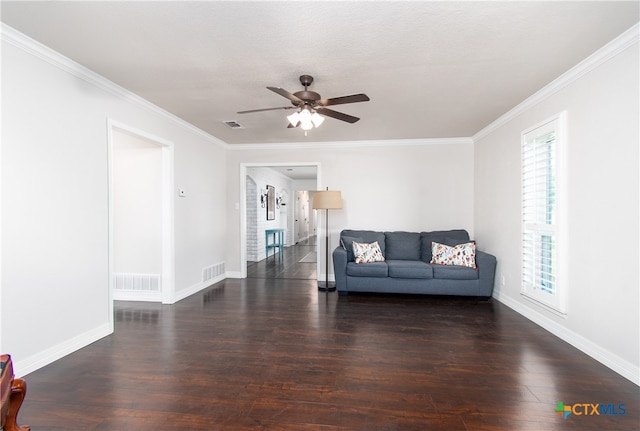 unfurnished living room with dark wood-type flooring, ornamental molding, and plenty of natural light