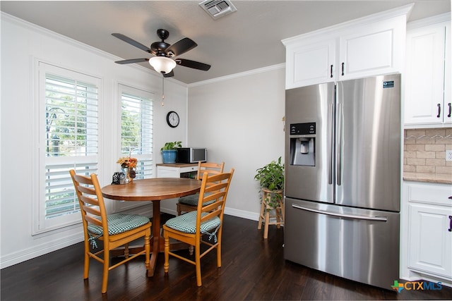 dining space featuring ornamental molding, dark wood-type flooring, and ceiling fan