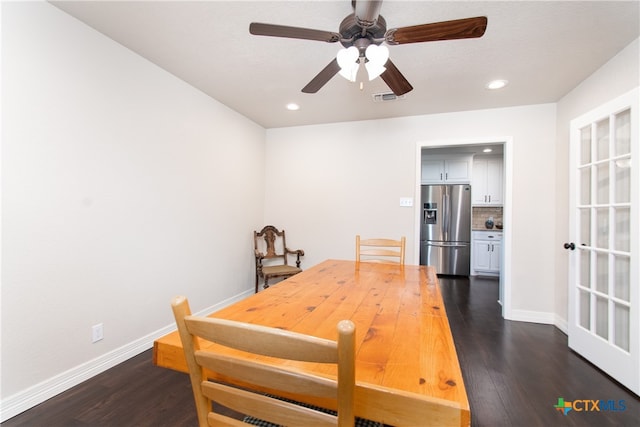 dining space with dark hardwood / wood-style flooring and ceiling fan