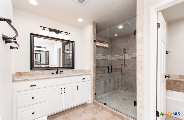 bathroom featuring shower with separate bathtub and vanity