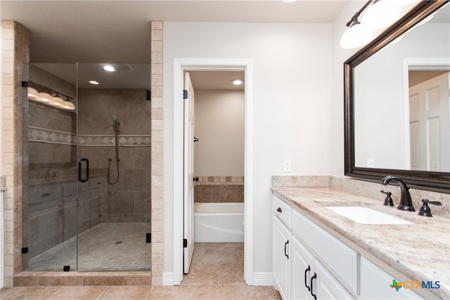 bathroom featuring vanity, tile patterned floors, and shower with separate bathtub