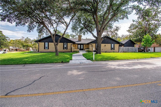 ranch-style home with a front lawn