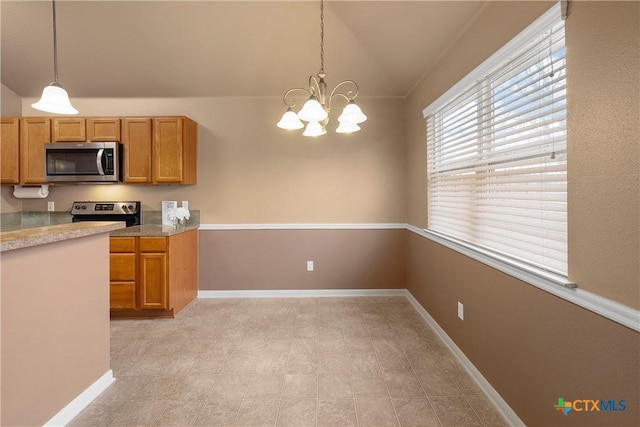 kitchen featuring lofted ceiling, appliances with stainless steel finishes, pendant lighting, and a notable chandelier