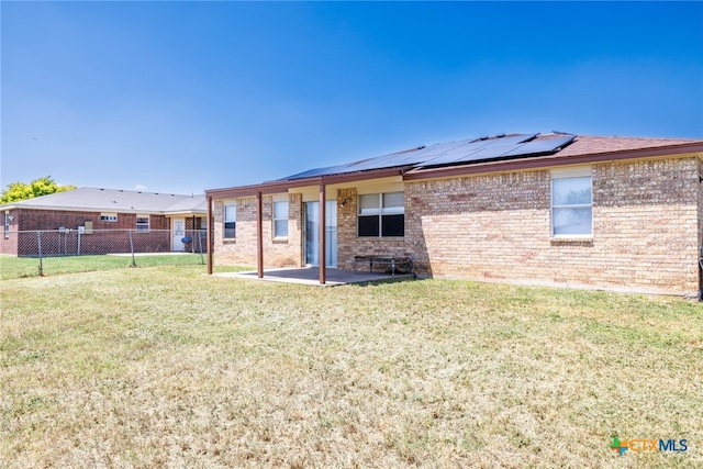4408 Secretariat Dr, Killeen, TX 76549 - back of house featuring solar panels, a patio area, and brick siding
