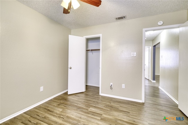 4408 Secretariat Dr, Killeen, TX 76549 - unfurnished bedroom with wood finished floors, a textured ceiling, baseboards, a closet, and ceiling fan