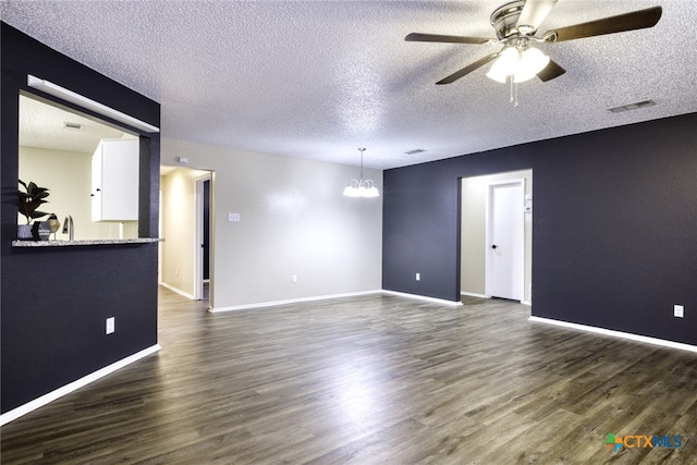 4408 Secretariat Dr, Killeen, TX 76549 - unfurnished room featuring a chandelier, ceiling fan, dark wood finished floors, a textured ceiling, and baseboards