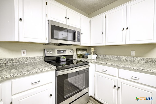 4408 Secretariat Dr, Killeen, TX 76549 - kitchen with stainless steel appliances, white cabinetry, and light stone countertops
