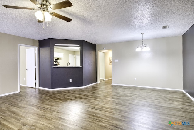 4408 Secretariat Dr, Killeen, TX 76549 - unfurnished living room featuring a textured ceiling, a ceiling fan, a chandelier, wood finished floors, and baseboards