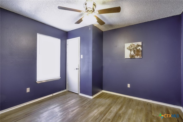 4408 Secretariat Dr, Killeen, TX 76549 - spare room with wood finished floors, a ceiling fan, a textured ceiling, and baseboards