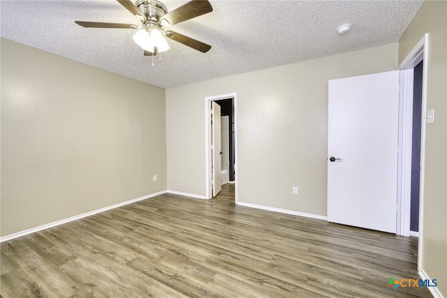 4408 Secretariat Dr, Killeen, TX 76549 - unfurnished bedroom featuring a textured ceiling, wood finished floors, baseboards, and a ceiling fan