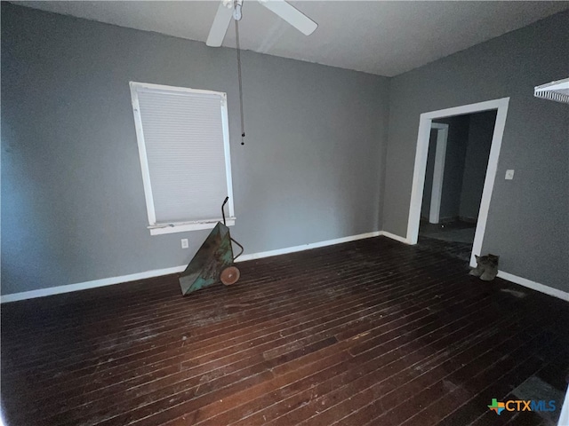 empty room featuring dark wood-type flooring and ceiling fan