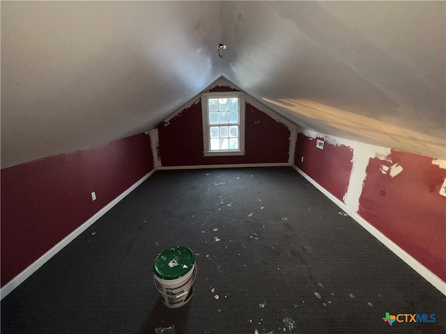 bonus room with lofted ceiling and carpet floors