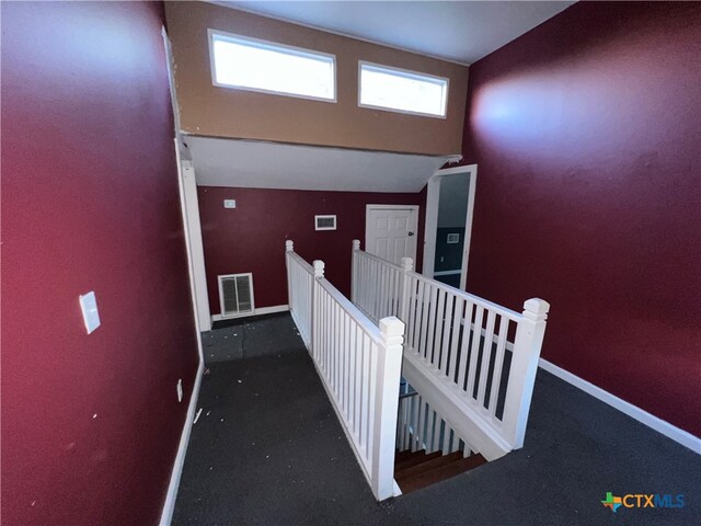 stairway featuring vaulted ceiling